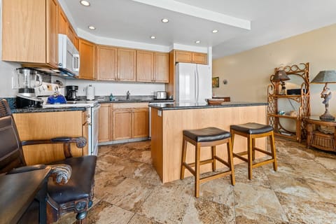 Kitchen island with 2 barstools.