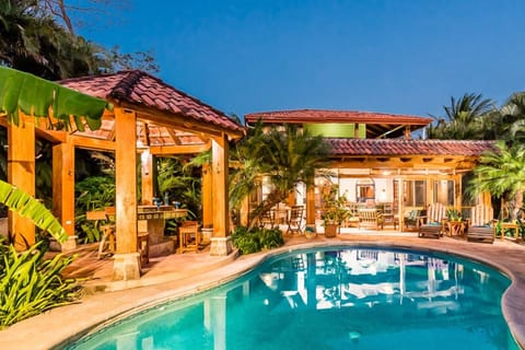 View of pool, grill and outdoor living area.