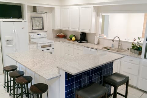 Large kitchen, new granite countertops, all appliances, TV and bar seating.
