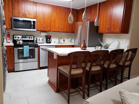 Full kitchen has everything for you to cook your meal. Full Size Refrigerator, Oven Range, Microwave, Toaster, coffee maker, rice cooker, blender & 4 seat bar