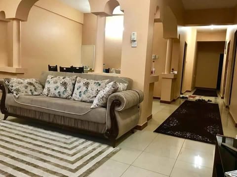 Luxury Apartment, Garden View | Living area | Flat-screen TV