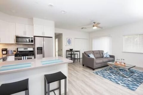 Sleek full-service kitchen seamlessly flows into the living area with access to patio and rooms.