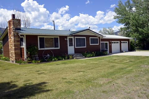 Front of house also showing sliding glass door which goes into a indoor porch.

