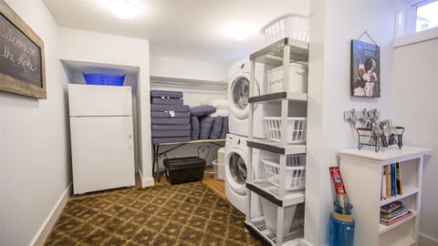 Laundry room with additional refrigerator. 