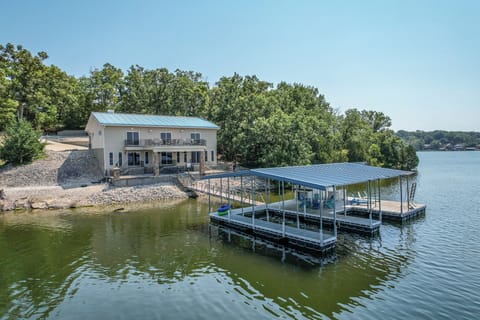 "Secluded lakefront retreat with private dock, lush trees, and serene views."