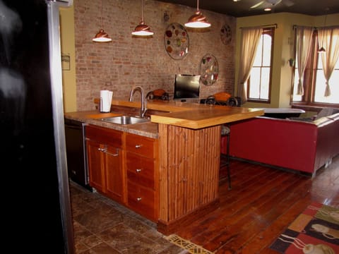 View of kitchen and living-room from the hallway. Loft beds are located above.