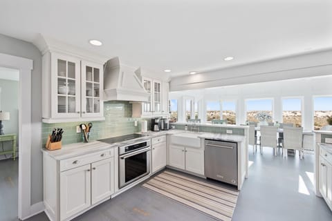 Kitchen is equipped with stainless steel appliances and has ocean views