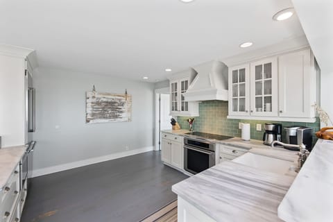 Kitchen is equipped with stainless steel appliances and has ocean views