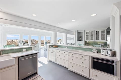 Kitchen is equipped with stainless steel appliances and has ocean views