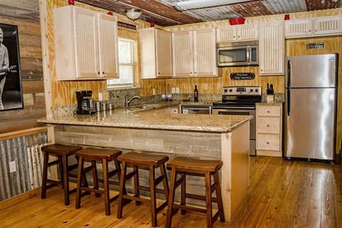 Kitchen - Open concept, stainless appliances, granite counters, custom cabinets.