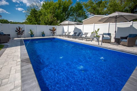 Fiberglass Saltwater 15x32 Heated Pool w/ Tanning Ledge, jets, and bubbles.  Hardscaping with firepit and seating.