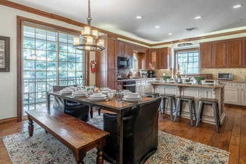 The heart of the home features a generous dining table perfect for shared meals, celebrations, and game nights, all open to the fully equipped kitchen.