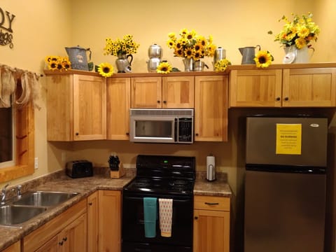 The kitchen is fully stocked with dishes, coffee maker, Crock-pot, & silverware.