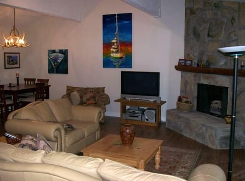 Open Great Room with 15' vaulted ceilings, oil on canvas art, rock fireplace
