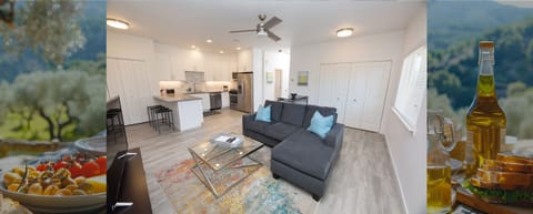 Upper-level living with sunlit space, cozy couch, smart TV, full kitchen, bar seating, and laundry. (1)