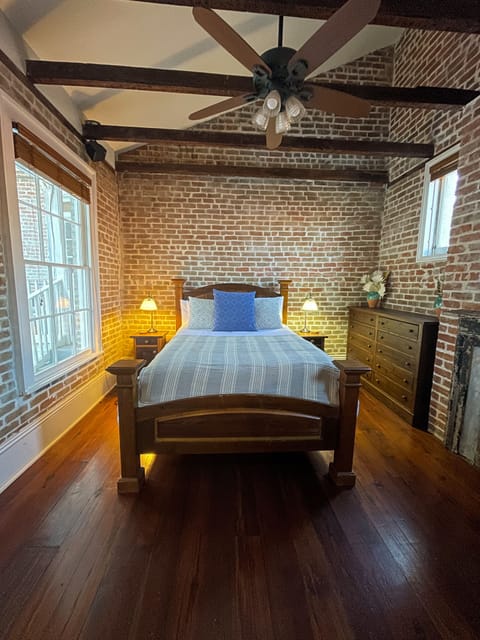 Unwind in a spacious bedroom featuring exposed brick walls