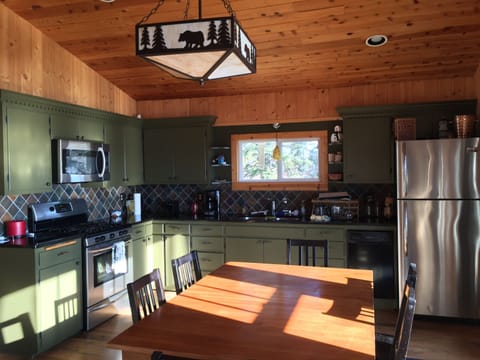 Kitchen is stocked with dishes, cooking utensils and all standard appliances