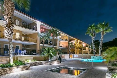 Two Swiming Pools and a Hot Tub....Our condo is behind the palm tree on the left