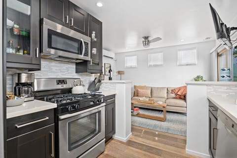 Stainless steel appliances including dishwasher and large refrigerator.