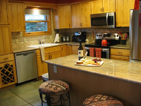 Updated, fully stocked kitchen with island seating for 2. 