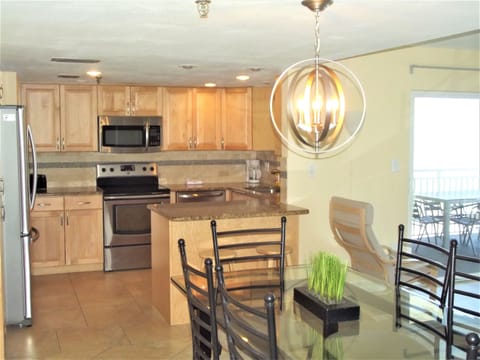 Inside dining room table can seat 8, plus 2 at the counter.