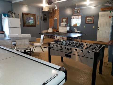 Large game room with air hockey, foosball and ping pong