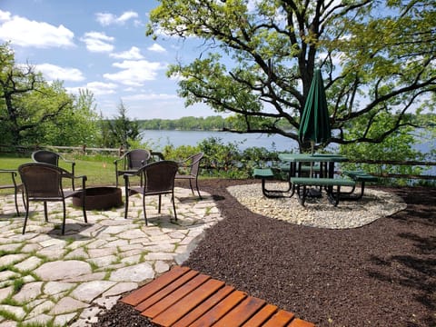 Brand new stone patio with campfire and lounging area for summer 2026!