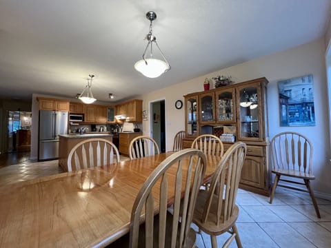 Dining table off kitchen, views out of large windows.