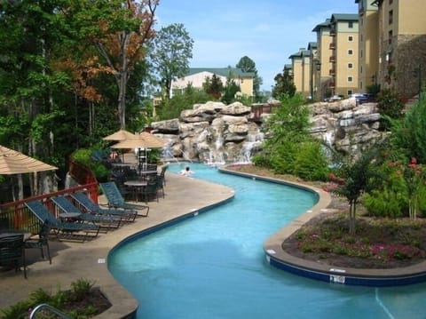 300'heated lazy river that flows around the tropical island with/rocks/waterfall