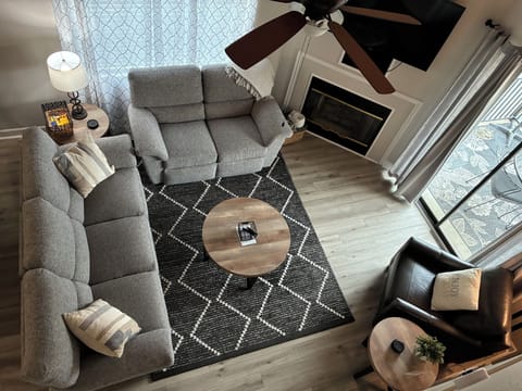 Living room with reclining sofa and loveseat. Smart TV.
