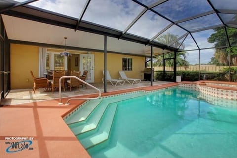 POOL/SPA WITH DINING AREA, LOUNGE CHAIRS AND BBQ GRILL