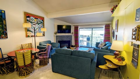 Living room with sofa bed, gas fireplace, and balcony w/ propane BBQ grill