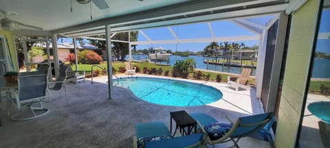 Outside screened lanai and pool overlooking dock and Dona Bay.
