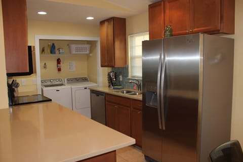Open kitchen with lots of space to work & serve. Full size washer & dryer