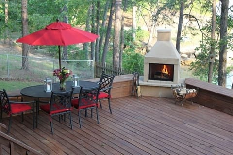 Deck with wood burning fireplace and dinning table.