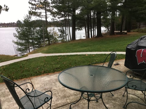 Lakeside patio with large gas Weber grill.