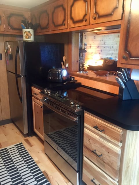 Updated stove and large refrigerator, classic clean cottage kitchen--
