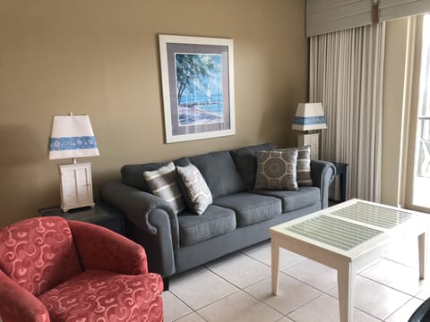 Relax in our spacious living room featuring balcony access and a flat screen TV!