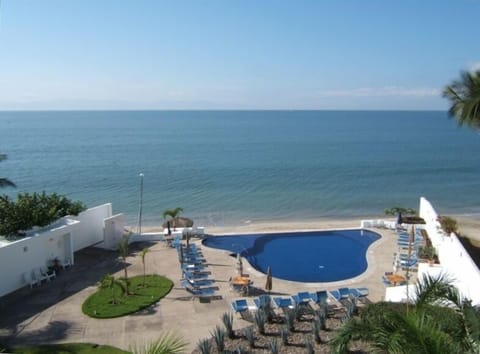 View over the gardens and pool from the balcony at #401, Condo del Mar