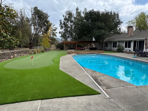 Pool Area with putting green, jacuzzi and gazebo