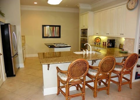 Kitchen with bar and additional seating. 