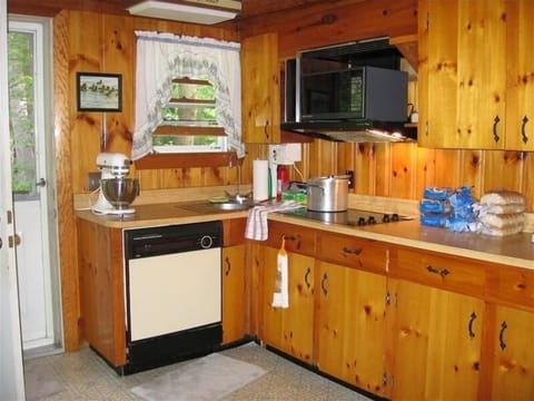 Full Kitchen with dishwasher overlooks lawn.
