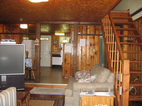 Living room and kitchen from the deck door, stairs lead to master bedroom