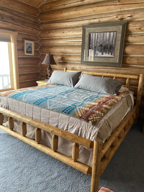 Primary bedroom with king size log bed , Pendleton blankets