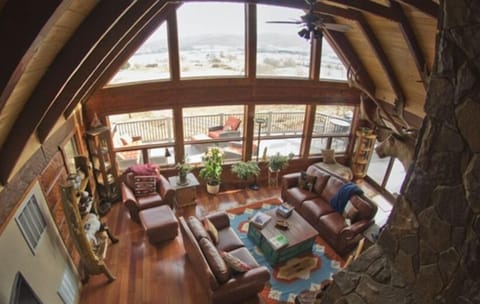 View from loft to living room with deck outside.