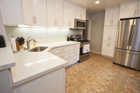 Cooks kitchen with quartz countertops.