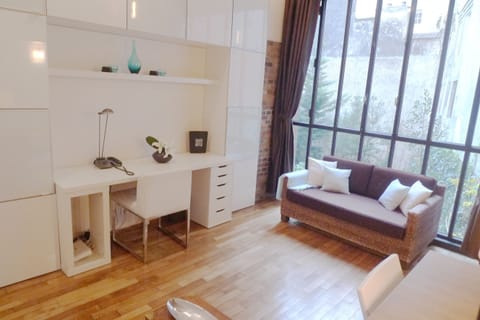 Desk, convertible sofa bed and bay window view over the courtyard greeneries