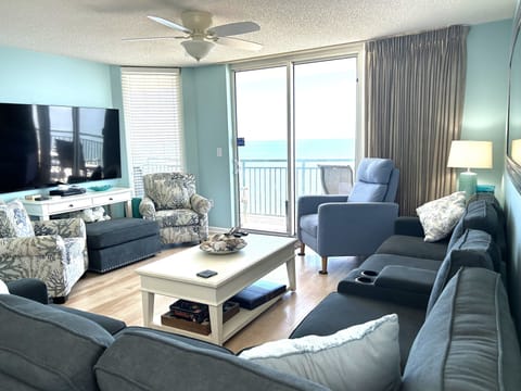 Living area with new sectional and recliner looking out over the balcony