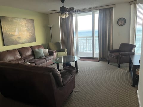 Oceanfront condo with balcony and direct views of beach and oceanfront pool.