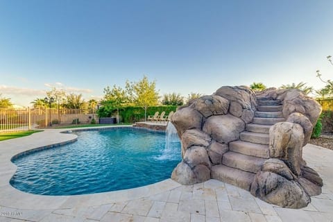 Heated pool with water slide and grotto. Approximately 9 ft deep.
